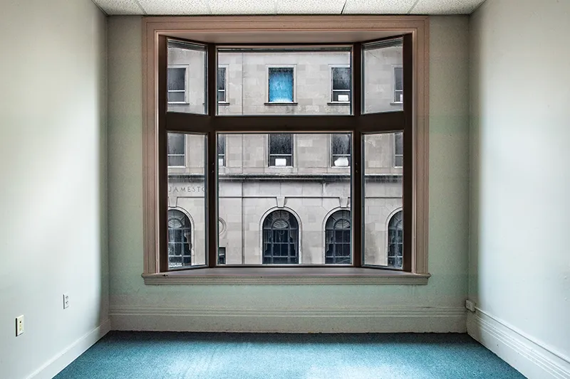 Interior image of office window looking out to historic building